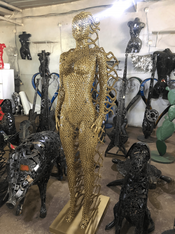 Handcrafted Golden standing woman. axle nuts female statue